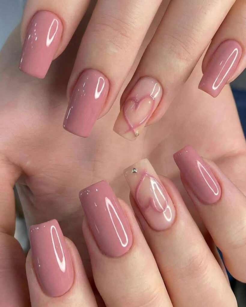 Glossy blossom pink square nails featuring an accent finger on each hand with a sheer base, a pink ribbon-style outline heart, and a small silver rhinestone.