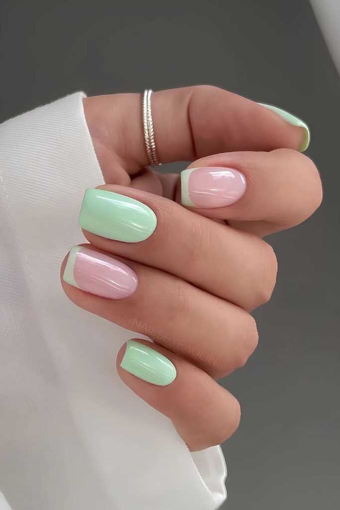 Short-to-medium squoval-shaped nails featuring a high-gloss finish with a mix of solid pastel mint green polish on the middle and pinky fingers, and a sheer natural pink base with matching mint green French tips on the index and ring fingers.