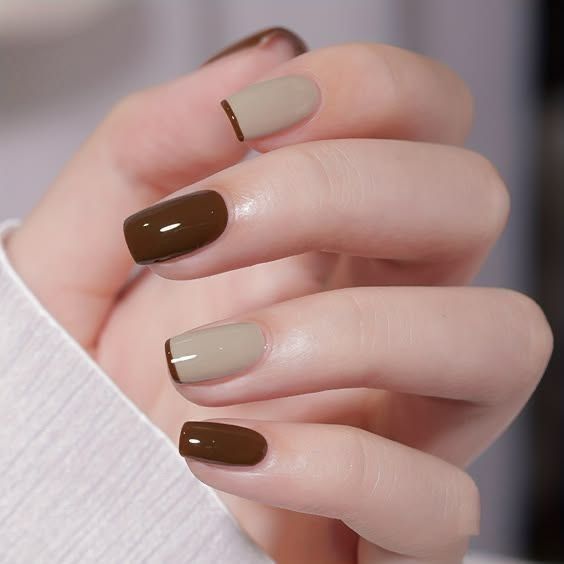 Short square-oval nails painted in an alternating pattern of glossy dark espresso brown and soft cream beige, with the beige nails featuring an ultra-thin dark brown micro-French tip.