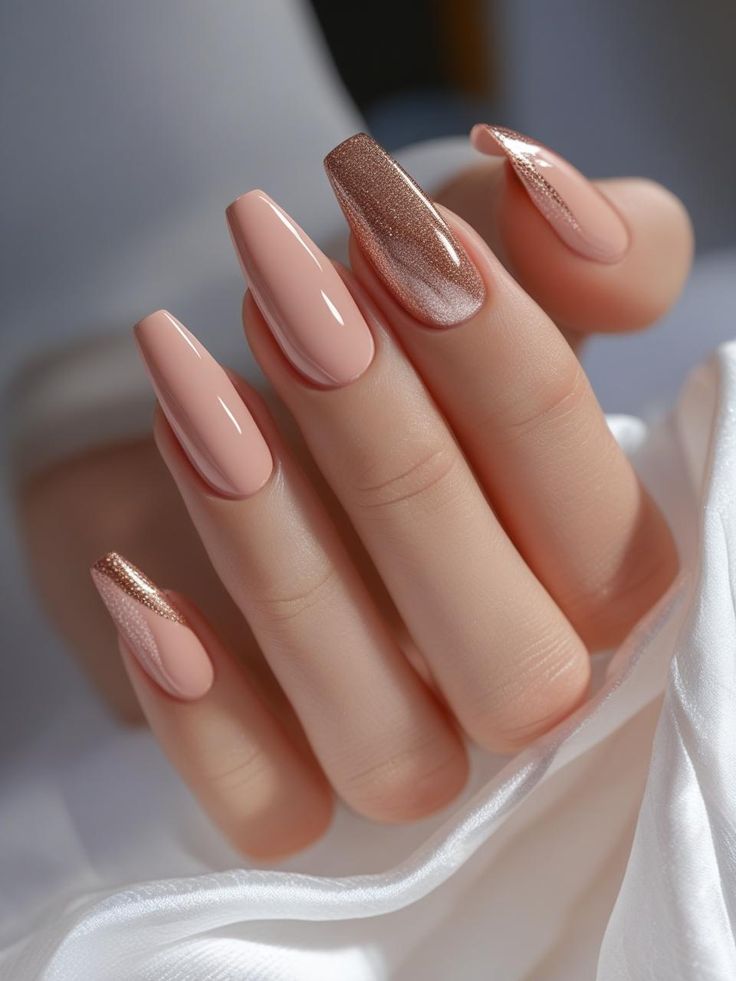 Soft nude pink nails with rose gold glitter accent nails and a glossy finish, creating an elegant and sophisticated manicure.