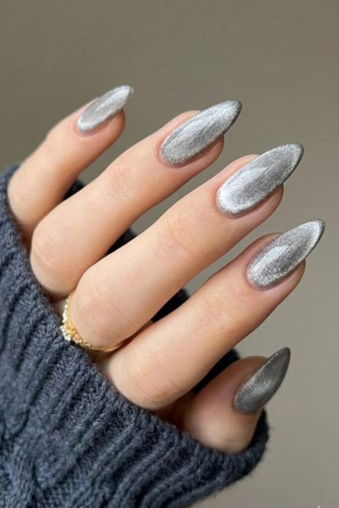 Classic silver cat eye nails with a magnetic chrome shimmer on almond-shaped nails.