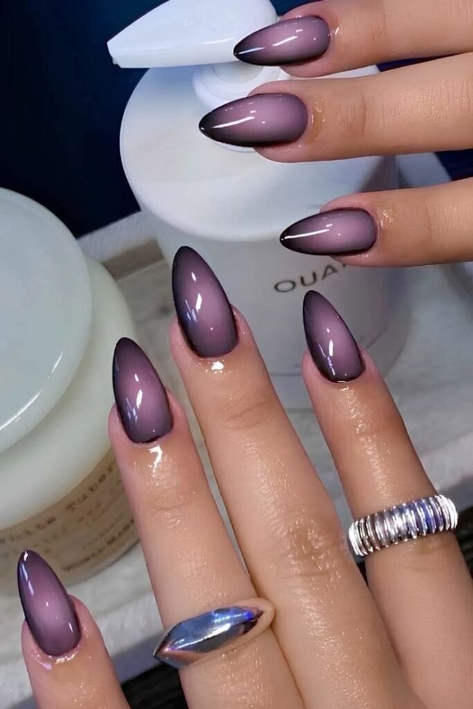 Smoky lavender cat eye nails with a glossy magnetic shimmer on almond-shaped nails.