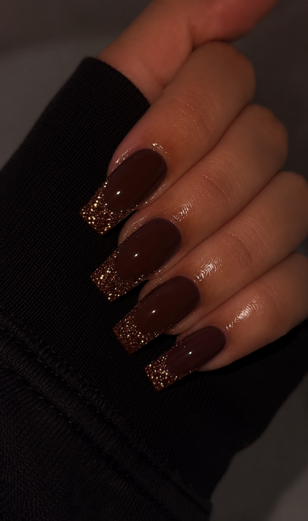 Glossy chocolate brown square nails with bronze glitter ombré tips, creating a glamorous and elegant fall manicure.