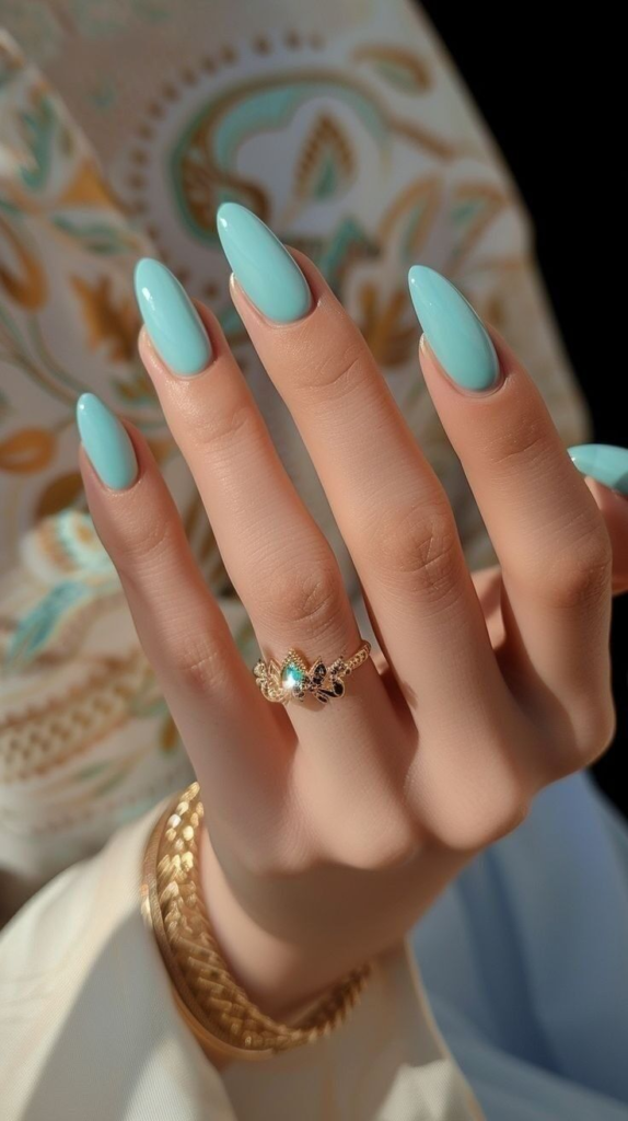 Glossy tiffany blue nails, solid pastel aqua-turquoise cream manicure on long almond nails, and vibrant minimalist summer solid-colored nail design.