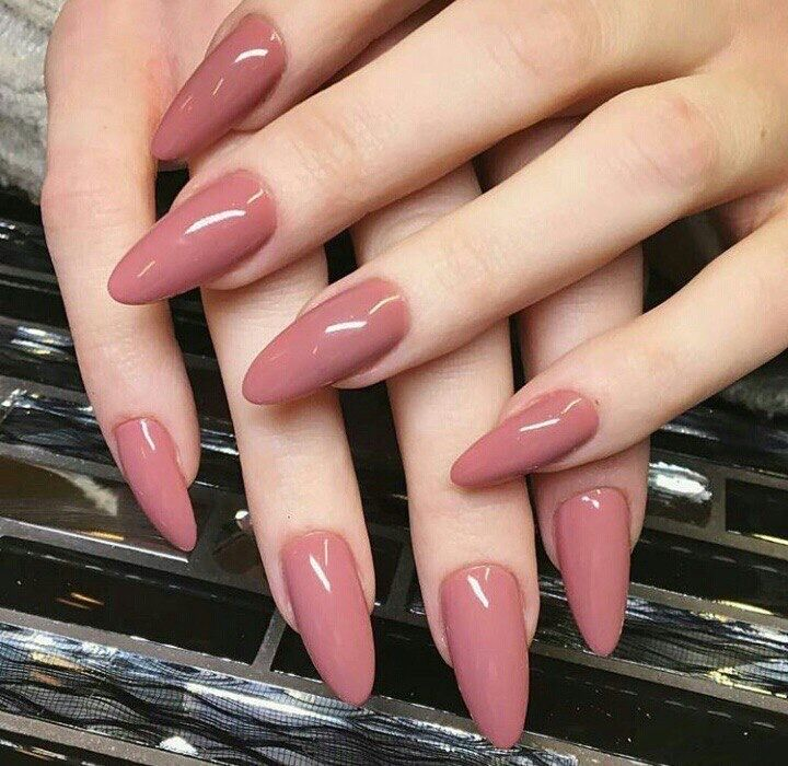 Classy mauve pink nails, glossy long stiletto almond manicure, and elegant dusty rose-pink solid color minimalist nail design.