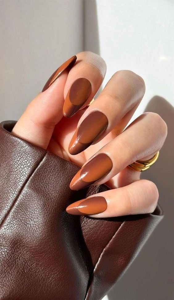 Two-tone brown abstract fall nails, glossy almond-shaped chocolate manicure, and minimalist modern autumn nail design.